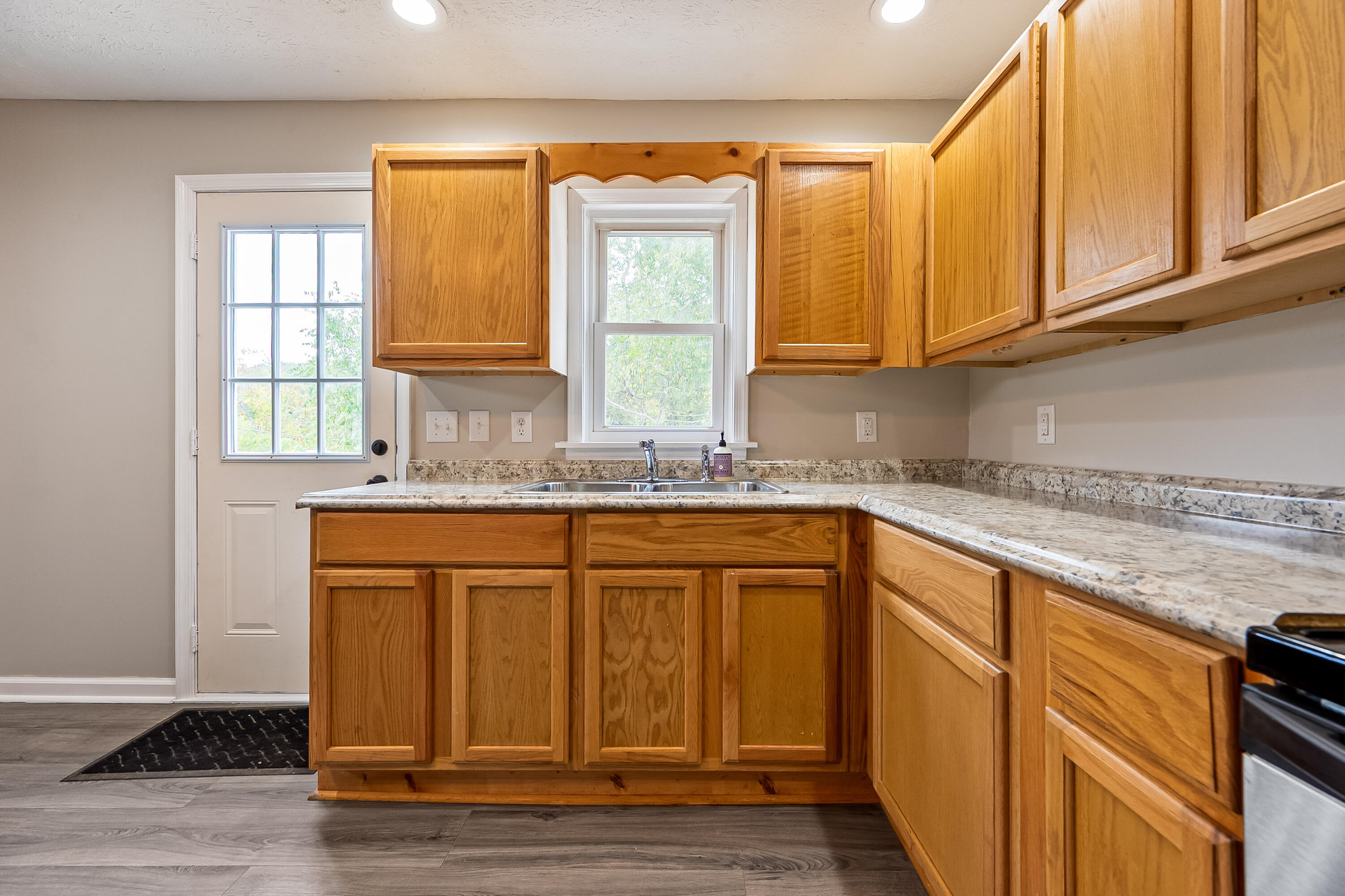 306 Lester Street Radford, VA 24141 - Photo 13 of 51 a kitchen with stainless steel appliances granite countertop a sink and cabinets