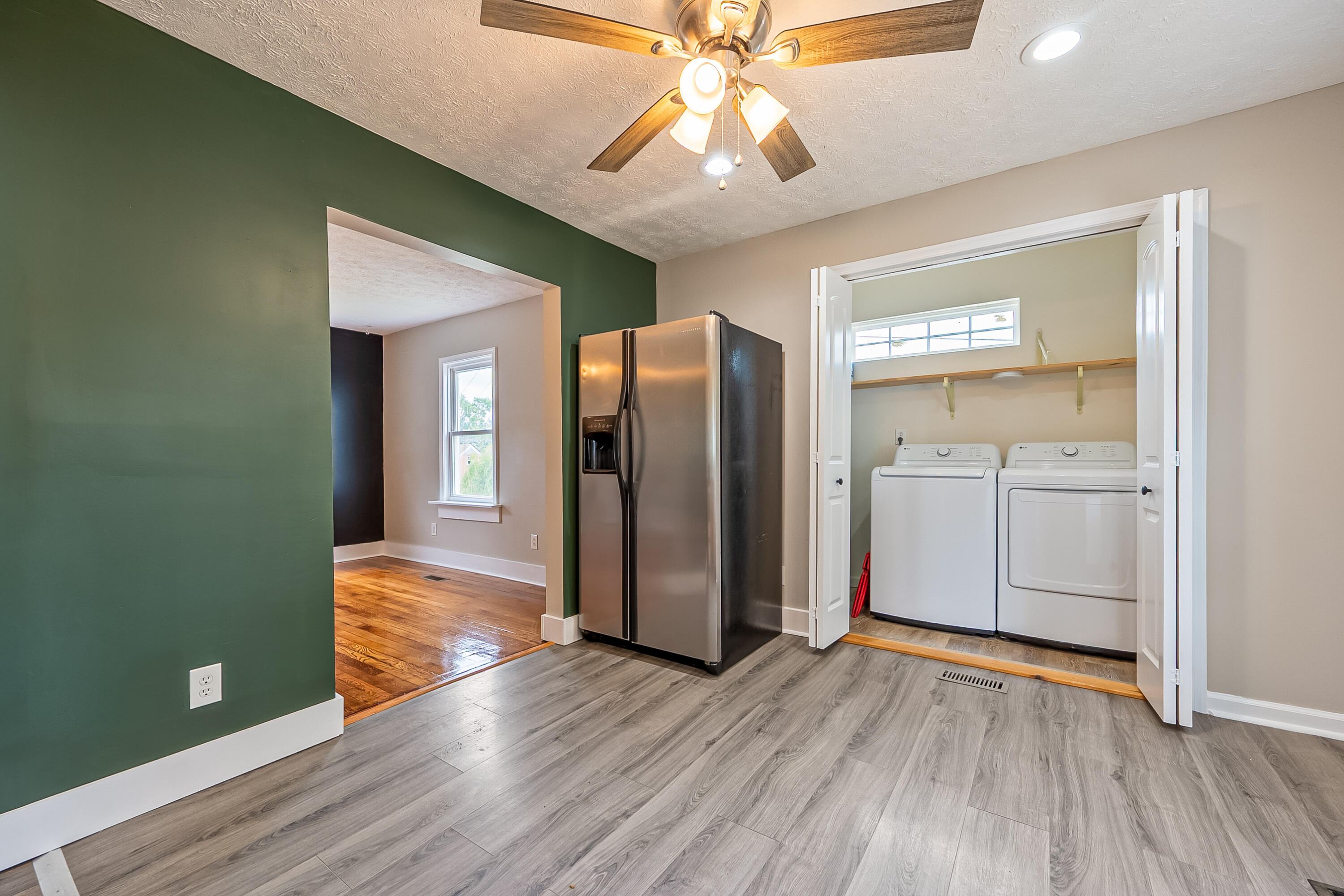 306 Lester Street Radford, VA 24141 - Photo 16 of 51 a view of a kitchen with wooden floor and a refrigerator