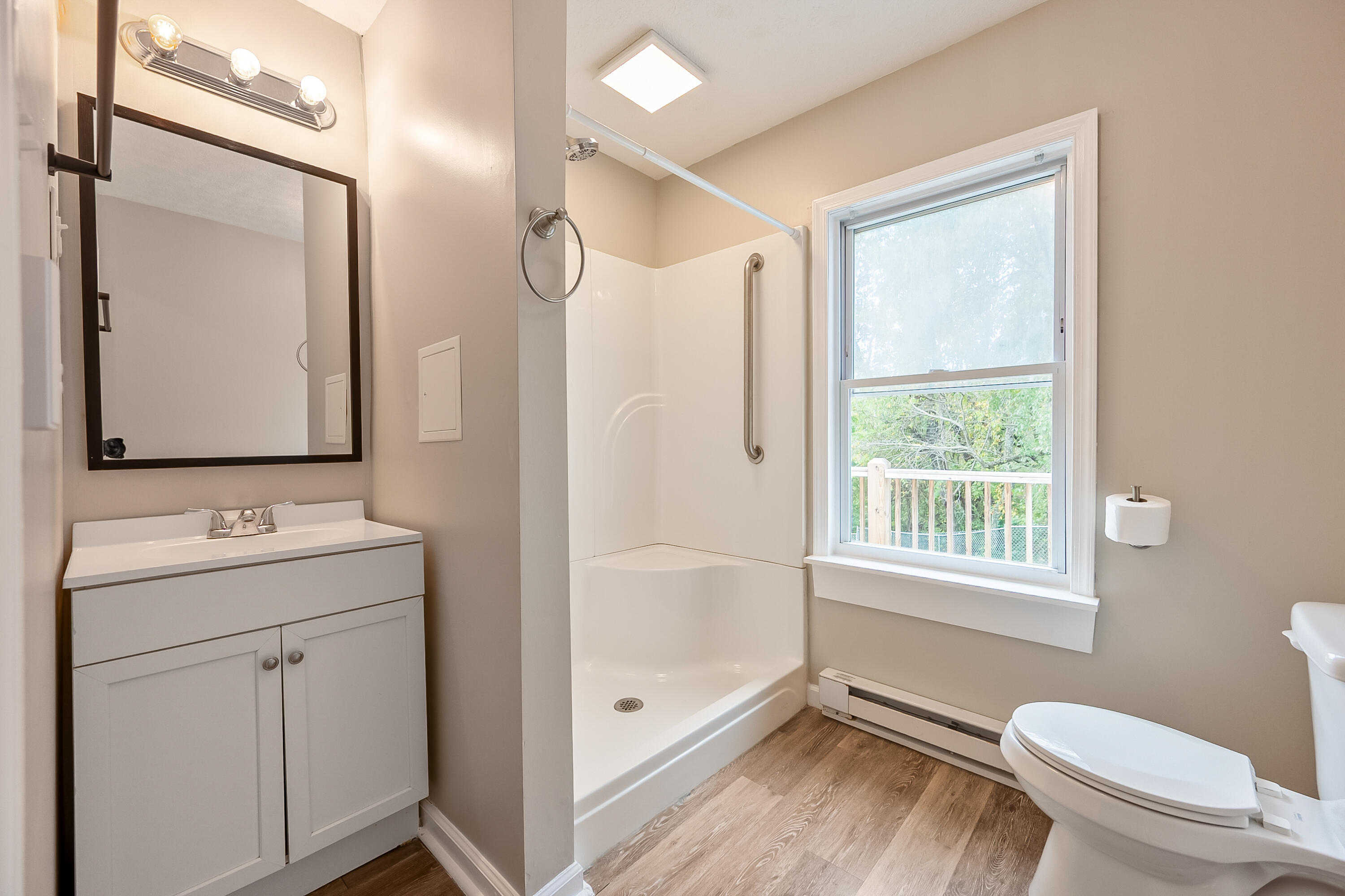 306 Lester Street Radford, VA 24141 - Photo 26 of 51 a bathroom with a granite countertop toilet a sink and a mirror
