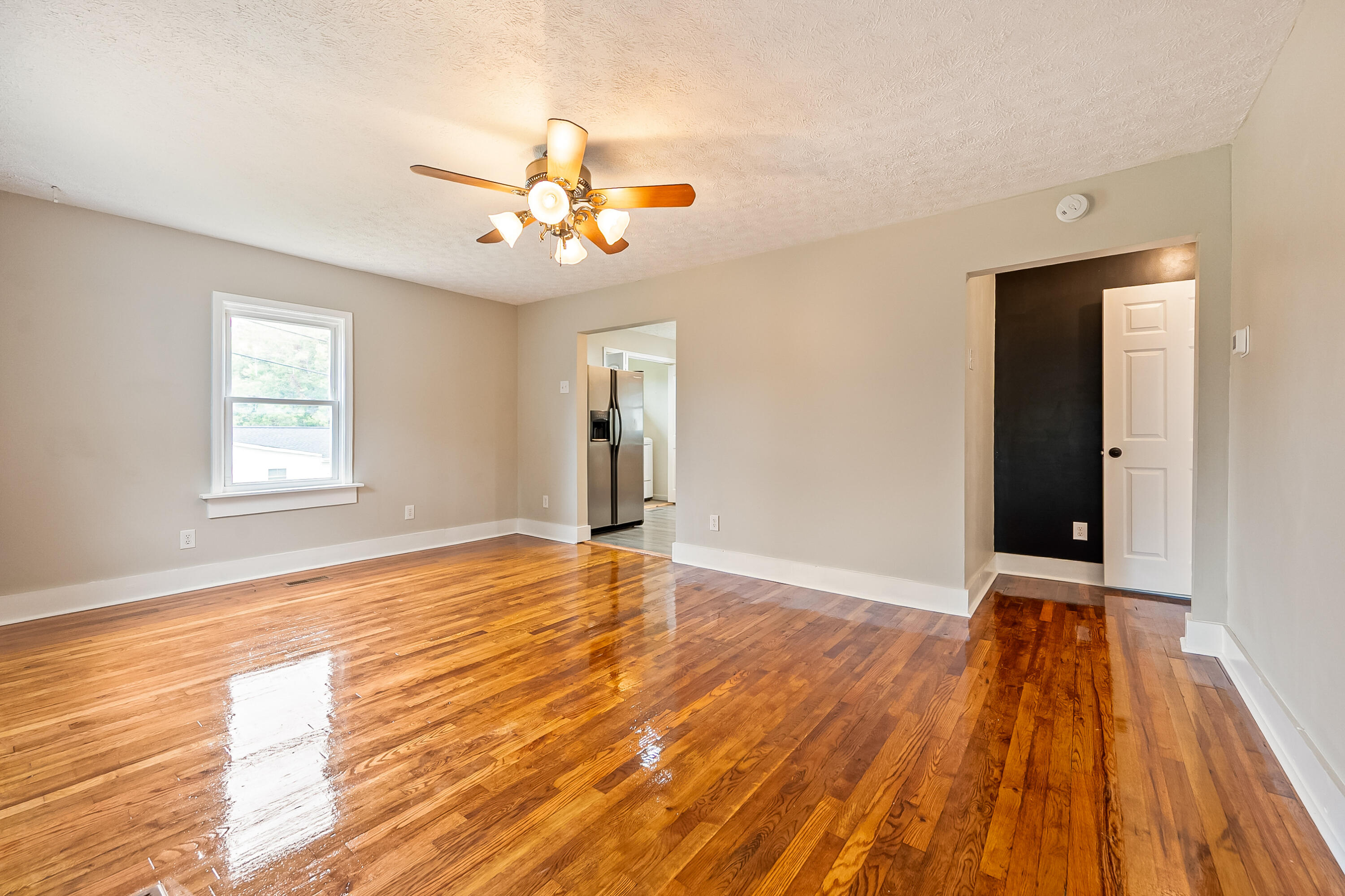306 Lester Street Radford, VA 24141 - Photo 6 of 51 a view of an empty room with wooden floor