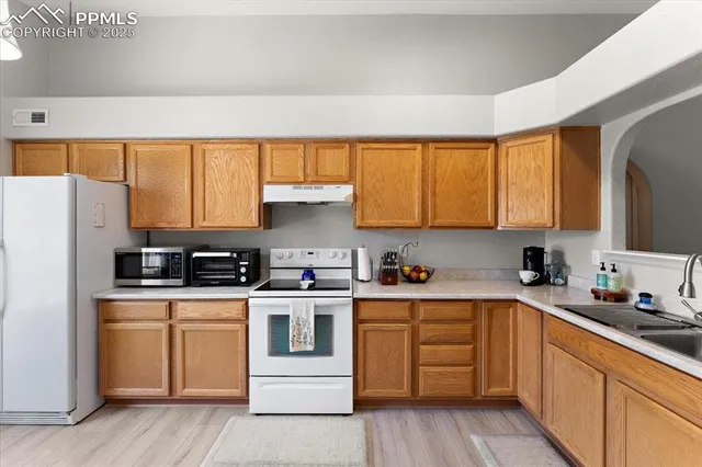 a kitchen with a white cabinets and white appliances