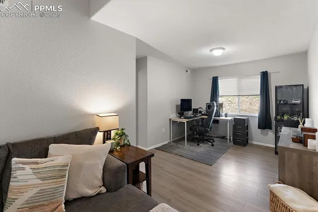 a bedroom with furniture and a large window