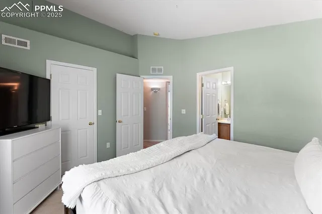 a bedroom with a flat screen tv and a bed