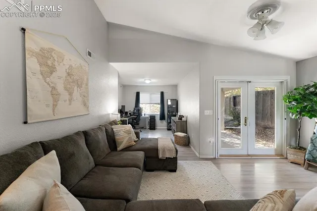 a living room with furniture and a potted plant