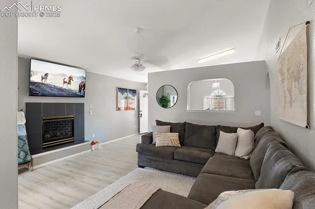 a living room with furniture a mirror and a fireplace