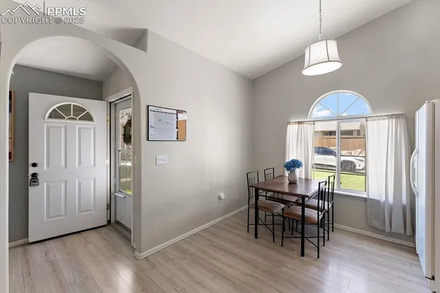 a view of a dining room with furniture window and wooden floor