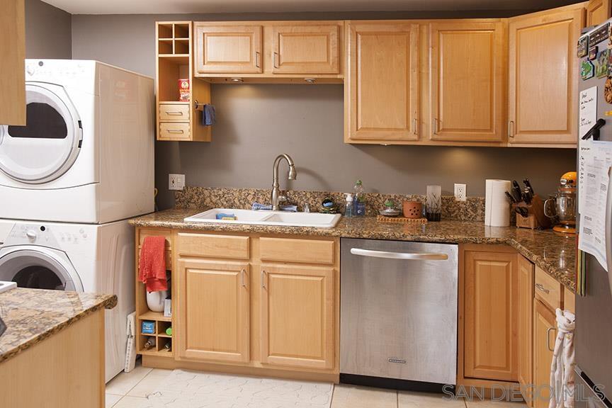 329 9th Street Del Mar, CA 92014 - Photo 13 of 29 a kitchen with stainless steel appliances granite countertop a sink a stove and cabinets