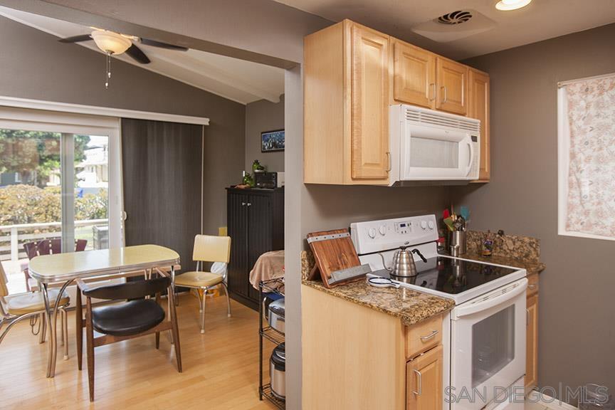 329 9th Street Del Mar, CA 92014 - Photo 14 of 29 a kitchen with a stove a table and chairs