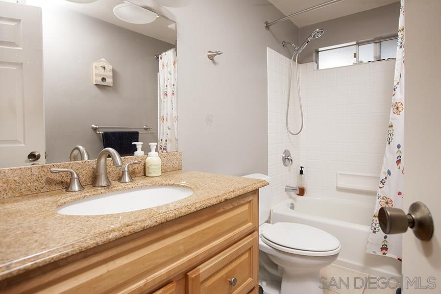 329 9th Street Del Mar, CA 92014 - Photo 17 of 29 a bathroom with a granite countertop sink and a mirror