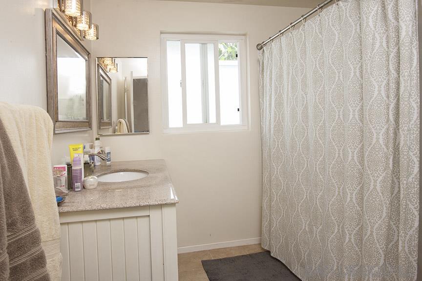 329 9th Street Del Mar, CA 92014 - Photo 27 of 29 a bathroom with a granite countertop sink and a mirror
