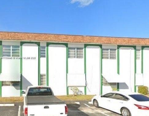 a living room with a bed furniture and a large window