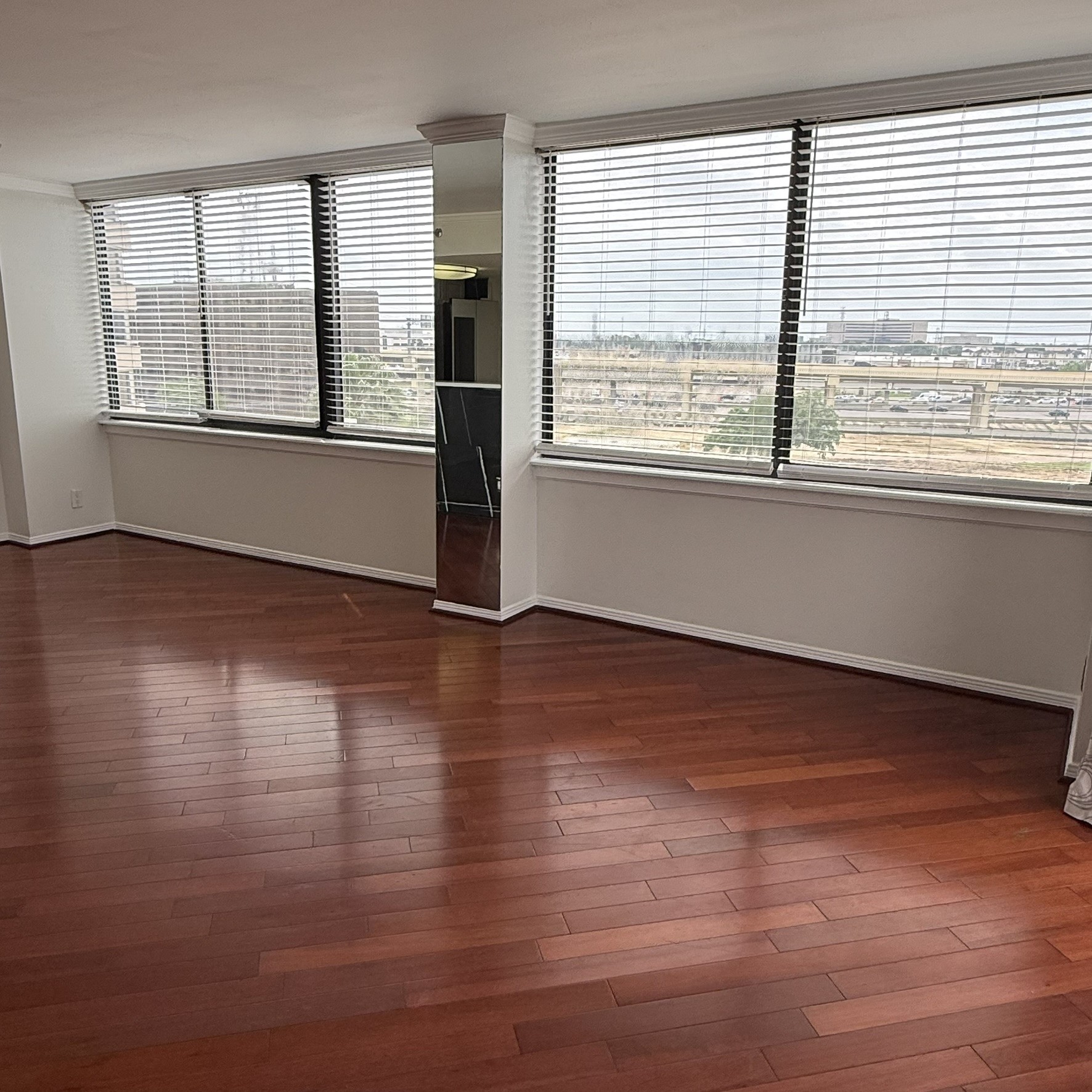 3525 Sage Road, Unit 716 Houston, TX 77056 - Photo 4 of 26 a view of an empty room with wooden floor and a window