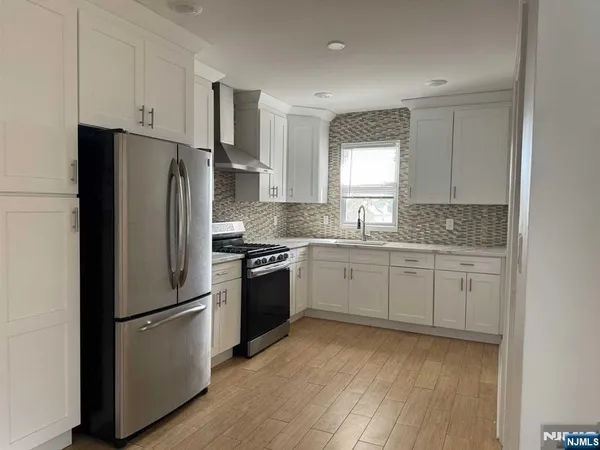 a kitchen with a refrigerator stove and sink