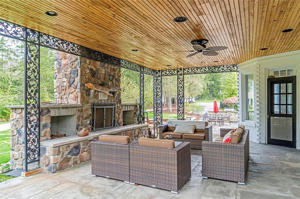 404 Beaver Road Sewickley, PA 15143 - Photo 19 of 24 Covered side porch with wood burning fireplace and accessed from both the Billards & the dining room.
