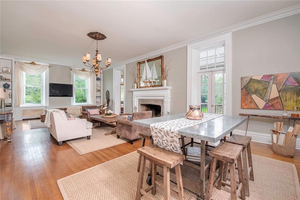 404 Beaver Road Sewickley, PA 15143 - Photo 4 of 24 Formal living room featuring an over sized wood burning fireplace, small terrace and another room with built in coffee maker / wet bar.