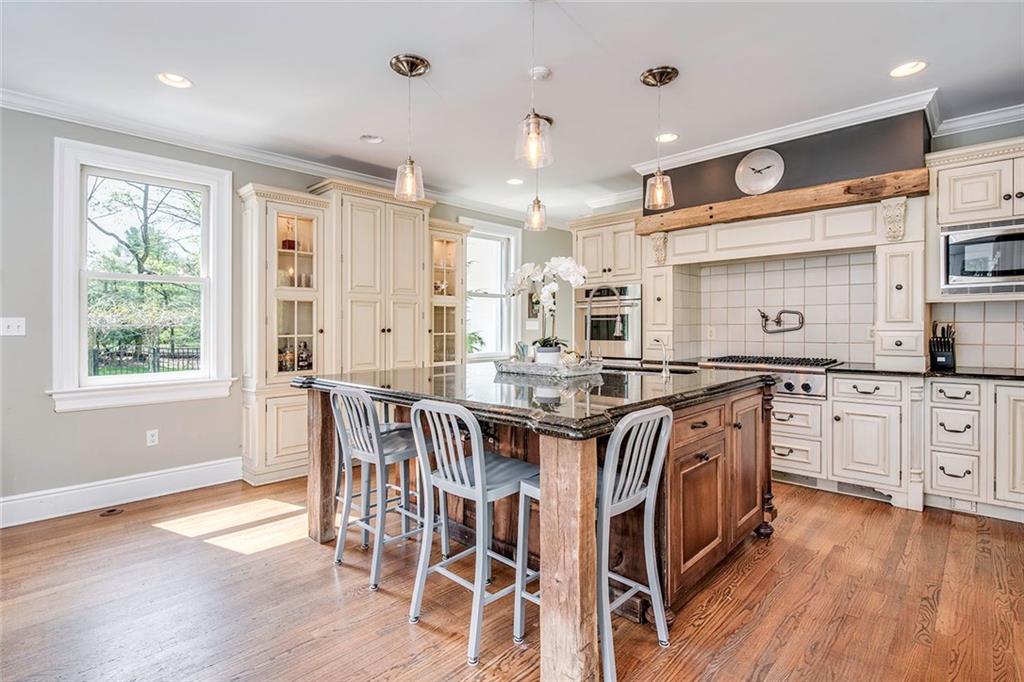 404 Beaver Road Sewickley, PA 15143 - Photo 8 of 24 Large granite counter top island with Thermadore stove, double oven, sub zero refrigerator, and warming drawer.