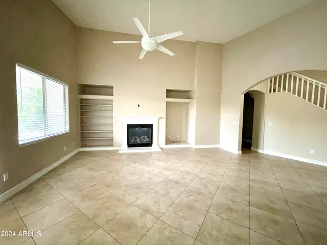 a view of empty room with a fireplace