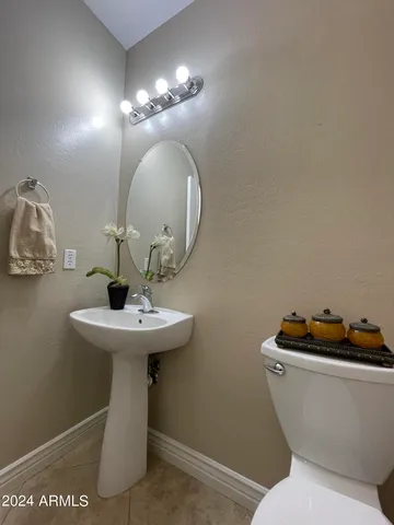 a bathroom with a toilet a sink and a mirror