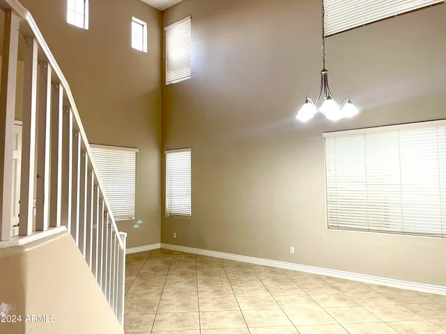 a view of a livingroom with wooden floor and stairs