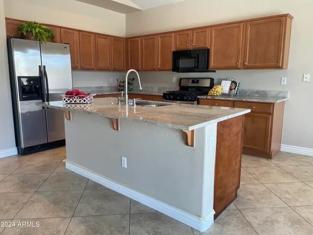 a kitchen with stainless steel appliances granite countertop a refrigerator sink and cabinets