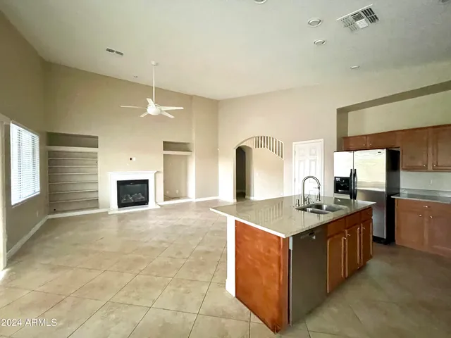 a kitchen with stainless steel appliances granite countertop a stove a sink and a refrigerator