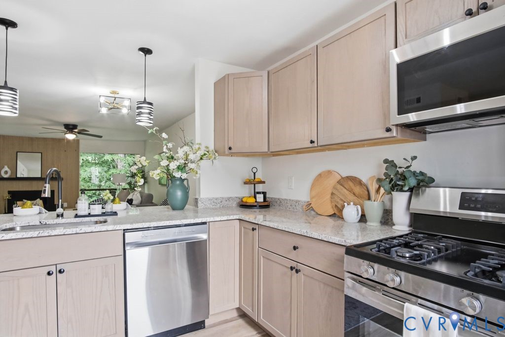 10270 Iron Mill Road Richmond, VA 23235 - Photo 9 of 29 Modern kitchen featuring stone countertops and sta
