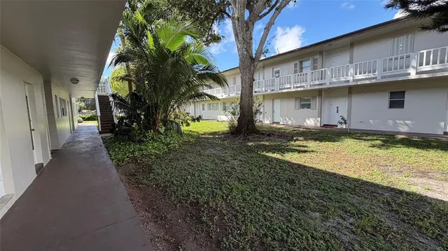 a view of a large building with many windows and a yard