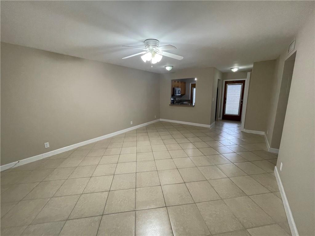 550 Southeast 2nd Avenue, Unit G5 Deerfield Beach, FL 33441 - Photo 14 of 28 an empty room with kitchen and chandelier fan