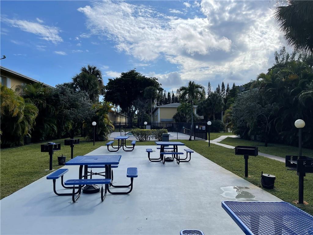 550 Southeast 2nd Avenue, Unit G5 Deerfield Beach, FL 33441 - Photo 3 of 28 an outdoor sitting area with couch and a table