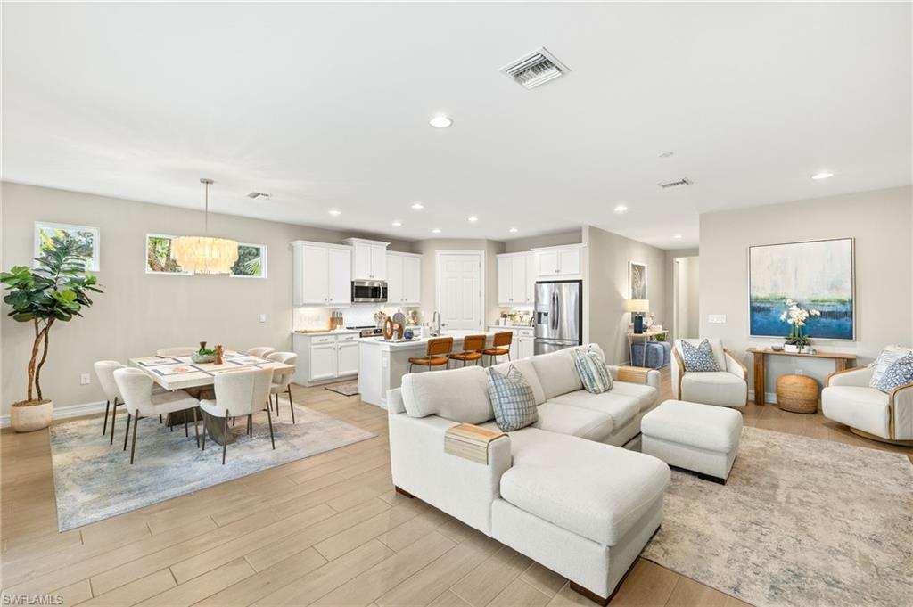 14546 Tropical Drive Naples, FL 34114 - Photo 3 of 39 a living room with furniture and view of kitchen