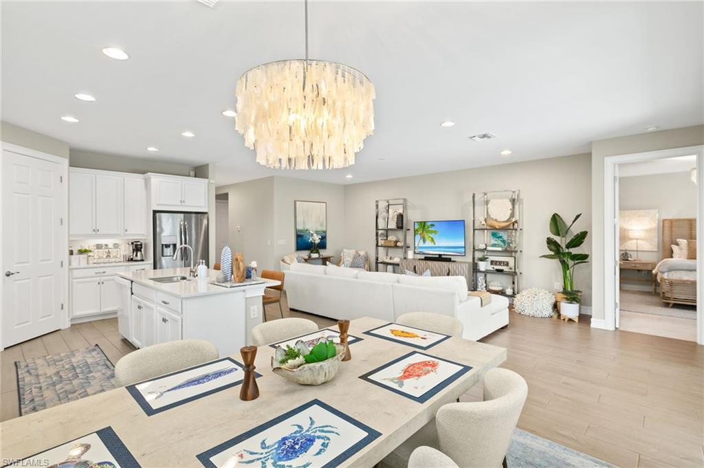 14546 Tropical Drive Naples, FL 34114 - Photo 4 of 39 a living room with furniture and a chandelier