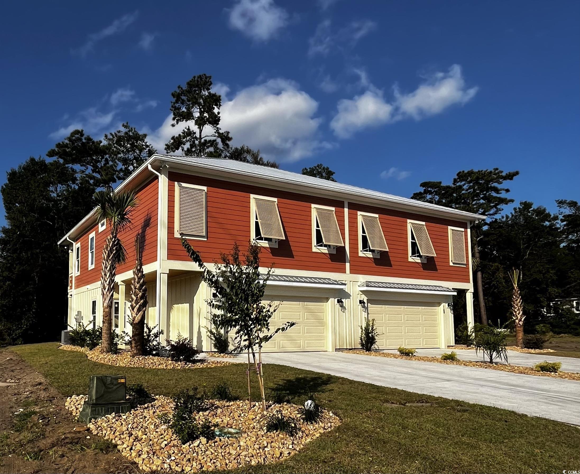 Multi unit property featuring cooling unit and a garage