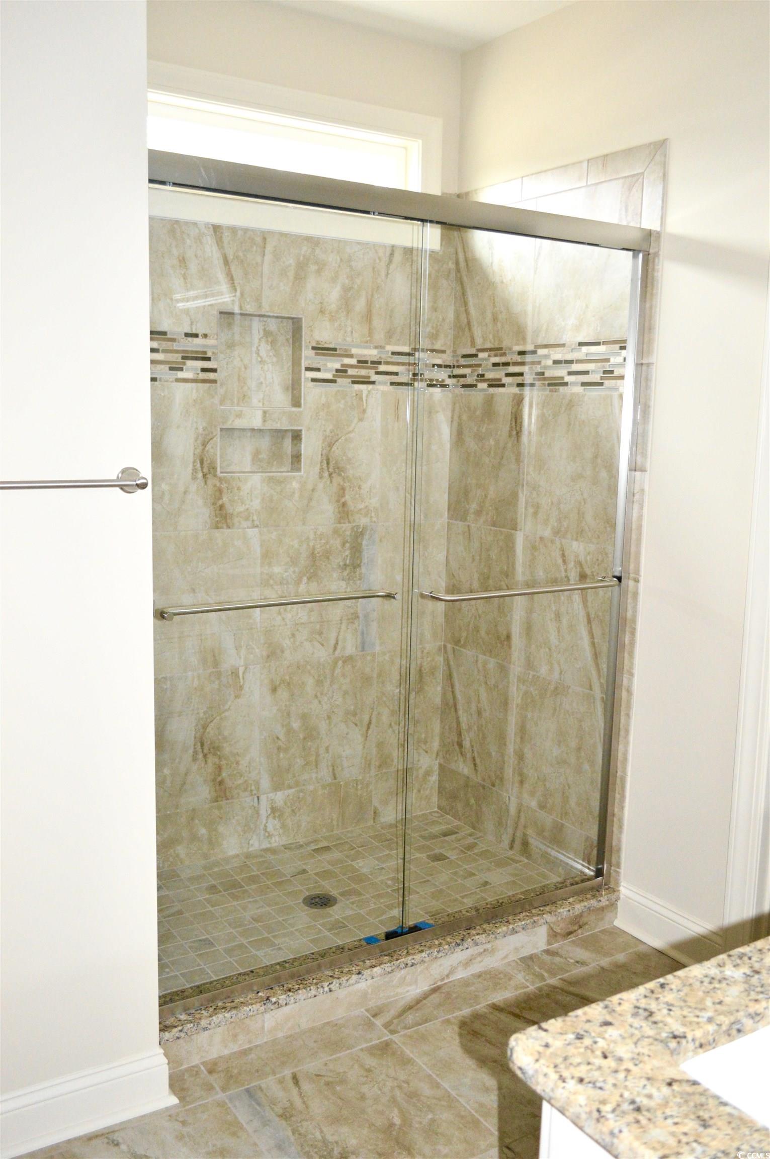110 Hallandale Lane Murrells Inlet, SC 29576 - Photo 13 of 37 Tile shower with transom lighting