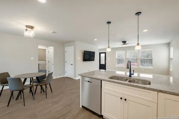 a kitchen with center island table and chairs