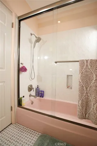 a bathroom with a bathtub and a shower