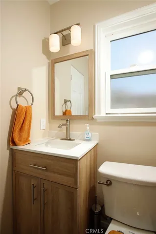 a bathroom with a sink a toilet and mirror
