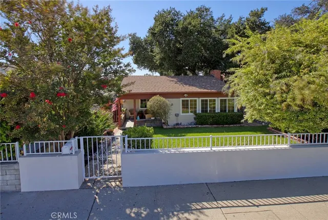 a view of house with outdoor space and garden