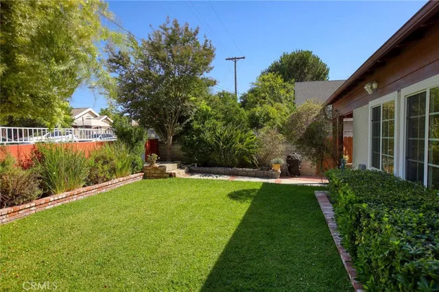 a view of a backyard with plants and a garden