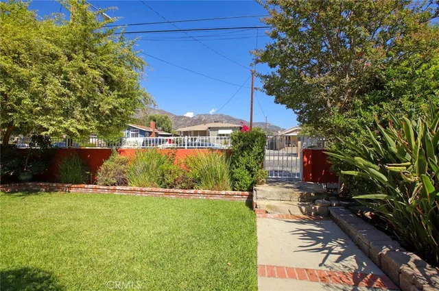 a view of backyard with a garden and trees