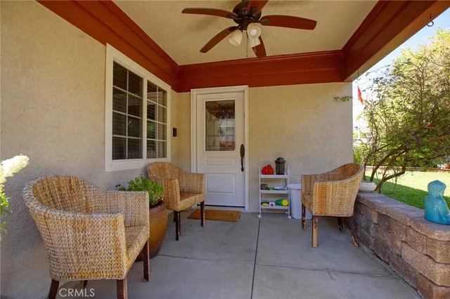 a balcony with furniture and a potted plant