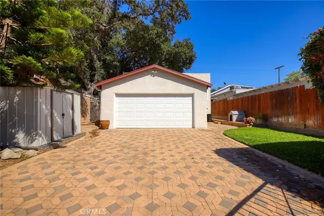 a view of backyard of house with green space
