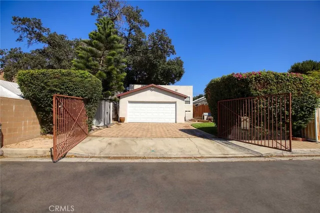 a street view with wooden fence and plants
