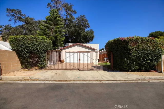 a view of a house with a yard covered in snow