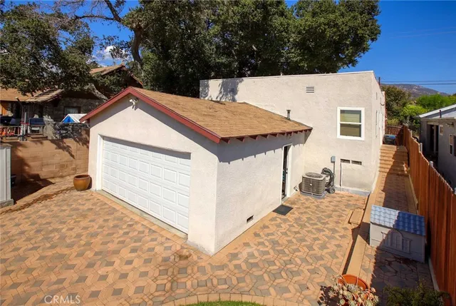 a view of a house with wooden fence