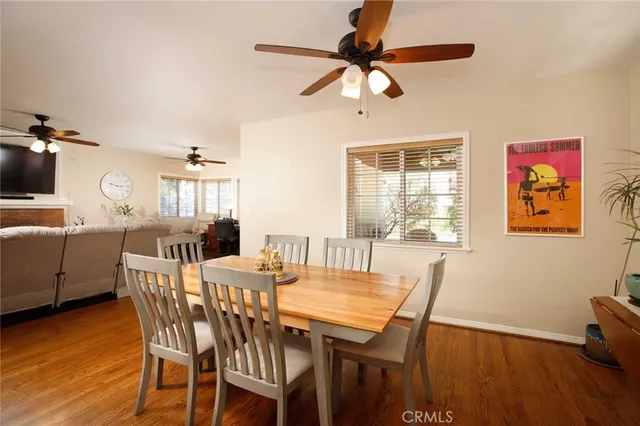 a view of a dining room with furniture window and wooden floor