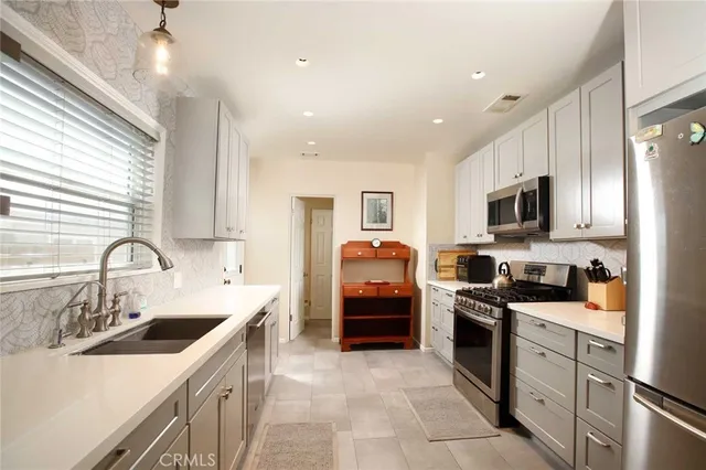 a kitchen with a sink stove and refrigerator