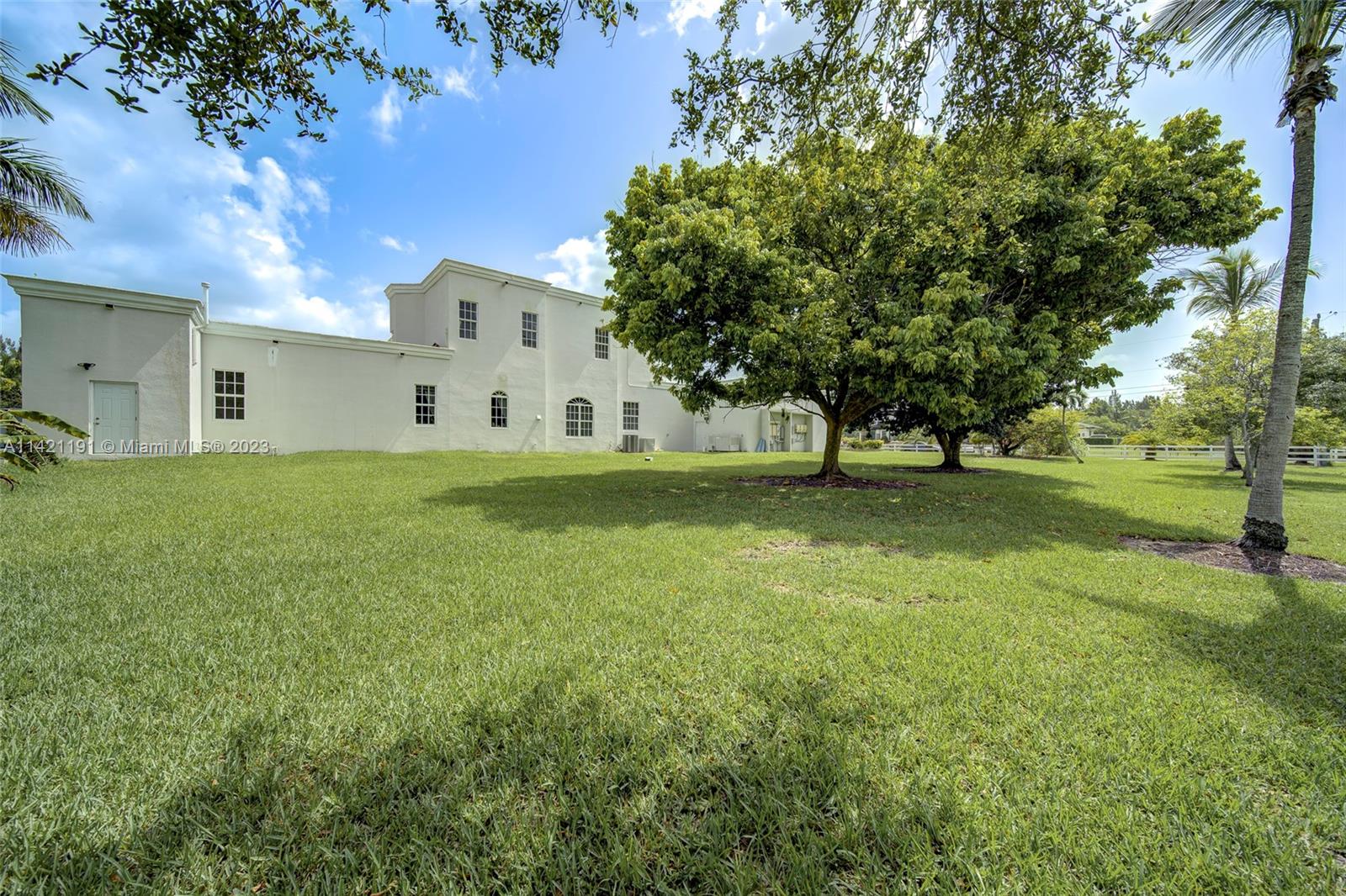5575 Southwest 198th Terrace Southwest Ranches, FL 33332 - Photo 54 of 60 a view of a house with a yard