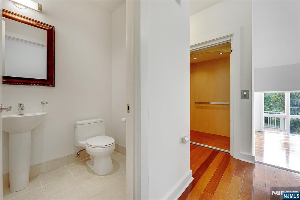 22 Vela Way Edgewater, NJ 07020 - Photo 13 of 43 a bathroom with a toilet sink and a mirror