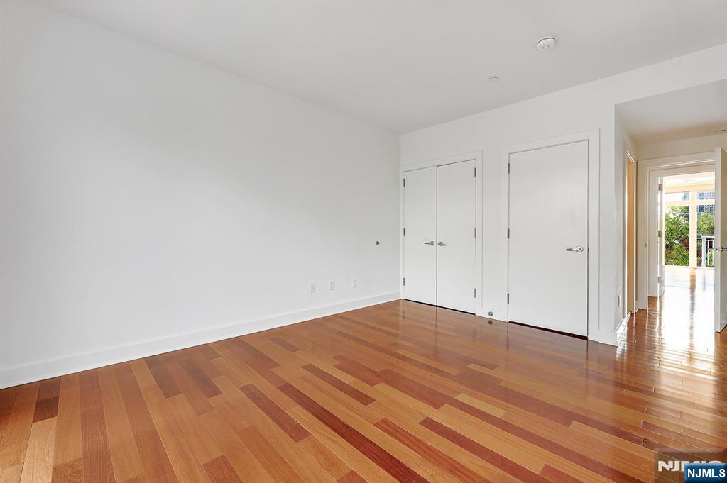 22 Vela Way Edgewater, NJ 07020 - Photo 21 of 43 a view of empty room with wooden floor
