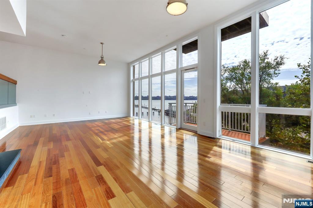 22 Vela Way Edgewater, NJ 07020 - Photo 4 of 43 a view of empty room with wooden floor and fan